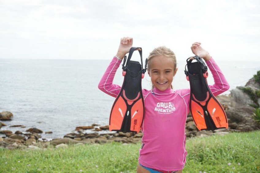 A person holding flippers by the sea. 3