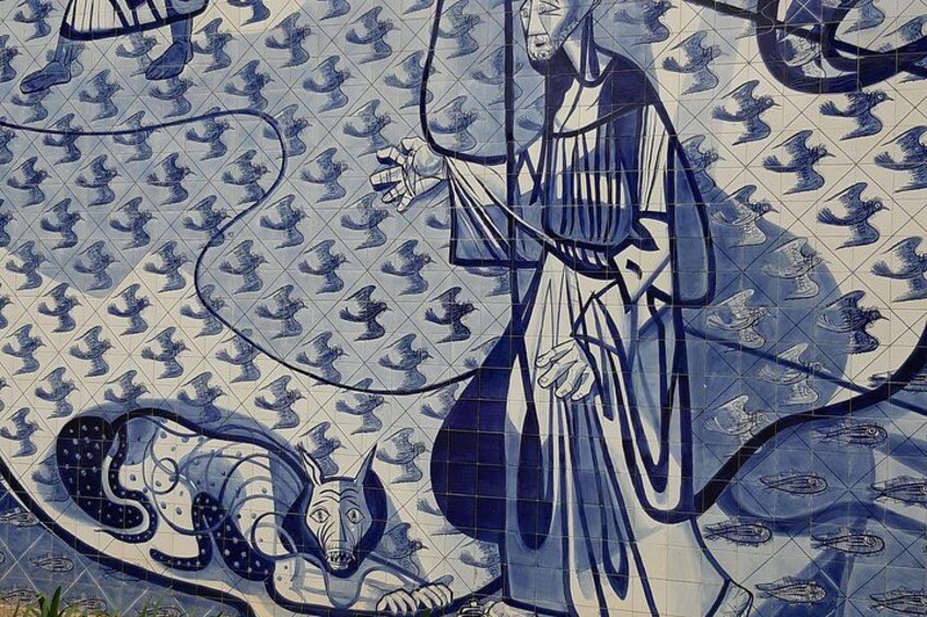 A tiled mural with a figure holding a birdcage, surrounded by birds and a snake. 5