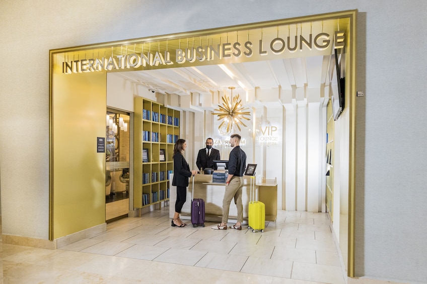 An international business lounge with a reception desk, bookshelves, and a decorative starburst light. 5