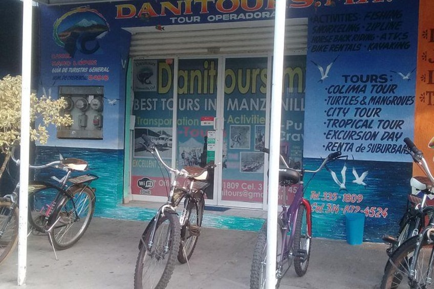 A tour operator's storefront with bicycles parked outside. 1