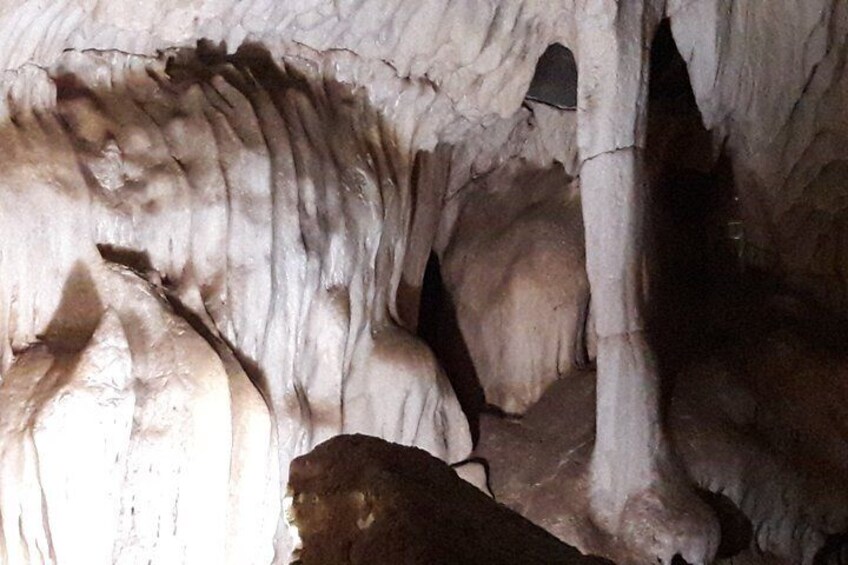 A cave interior with stalactites and stalagmites. 4