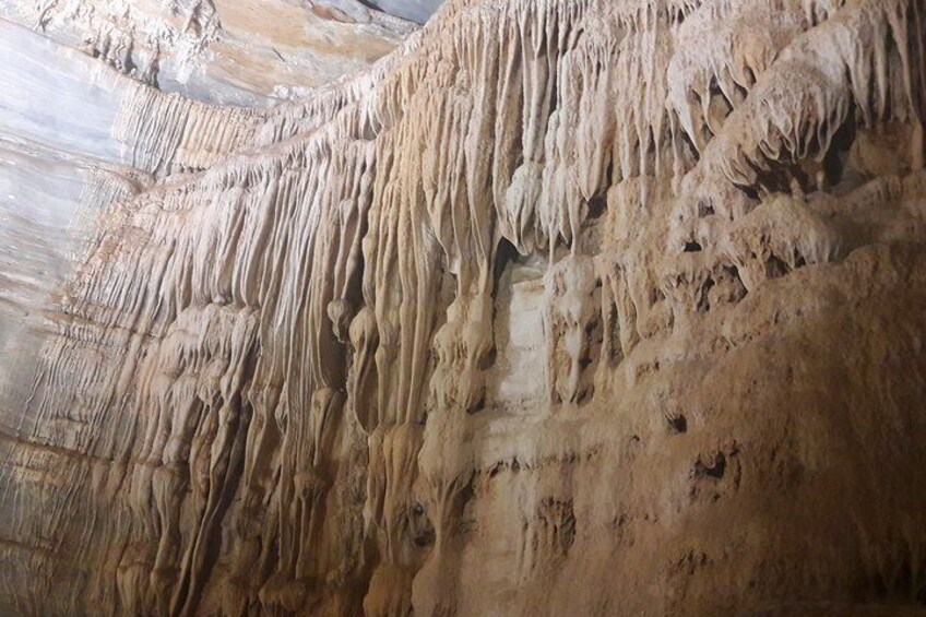 A cave with stalactites hanging from the ceiling. 3