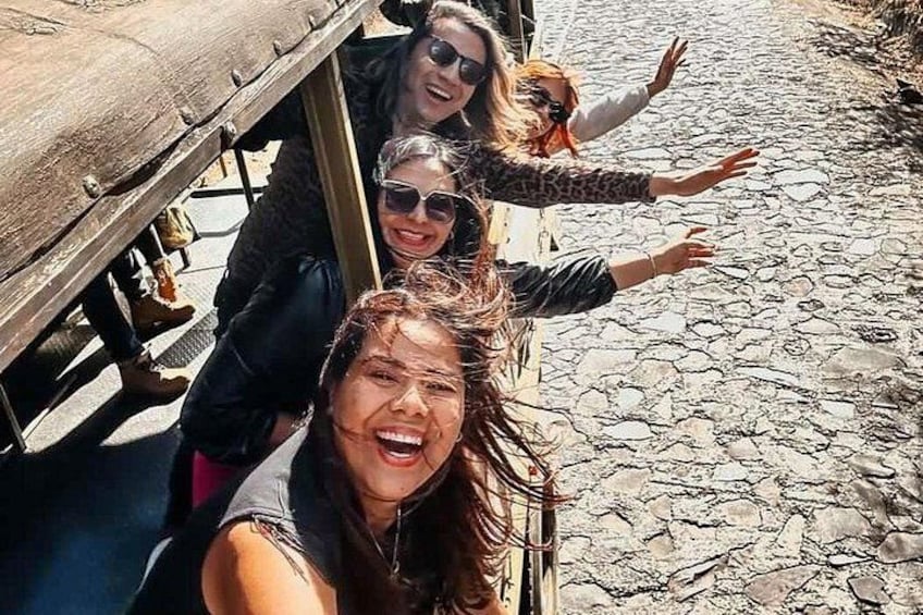 A group of people on a cobblestone street. 4