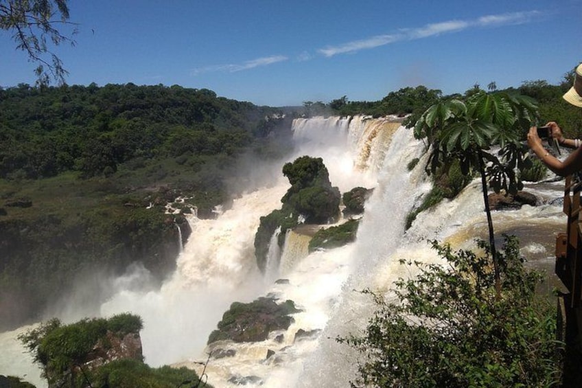 A large waterfall surrounded by lush greenery. 5