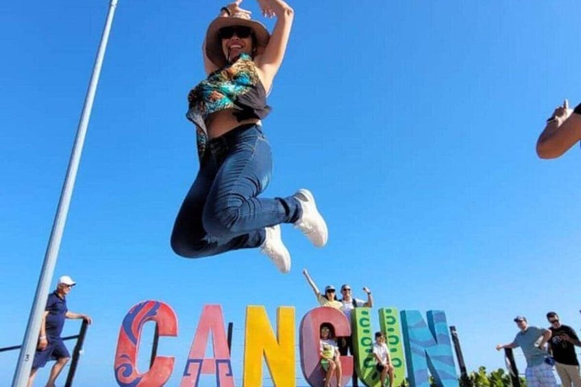 A person jumping in mid-air with a clear blue sky in the background. 3