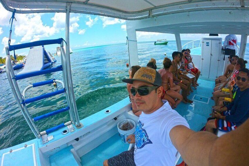 A group of people on a boat with a ladder and a small platform. 4