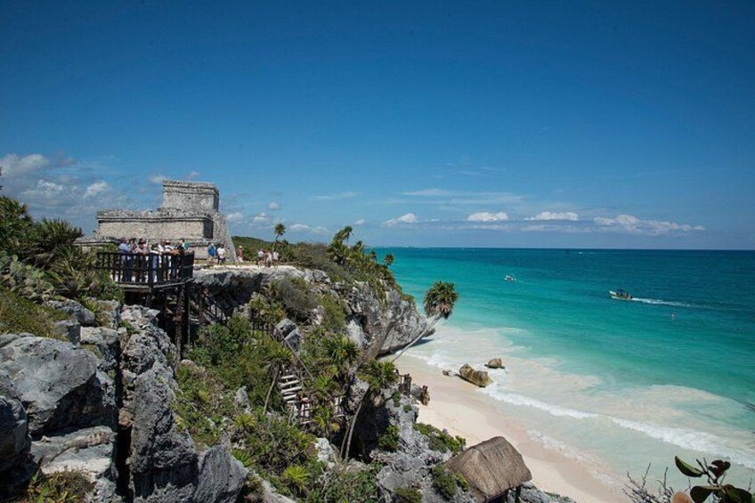 A coastal archaeological site with ruins and a beach. 2