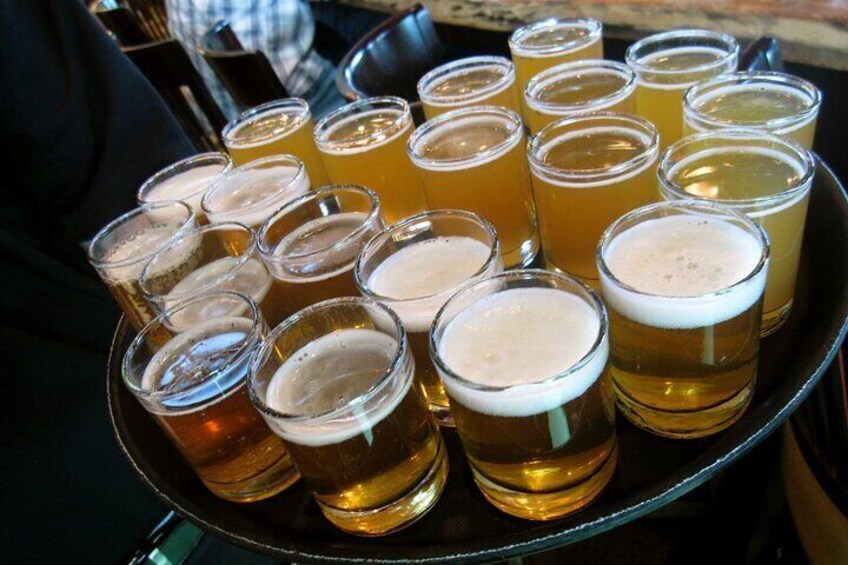 Un plateau rempli de verres à bière contenant une bière blonde dorée. 3