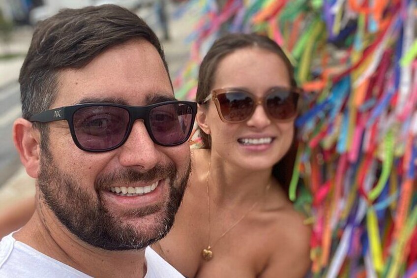 A person wearing a white shirt and sunglasses. 1