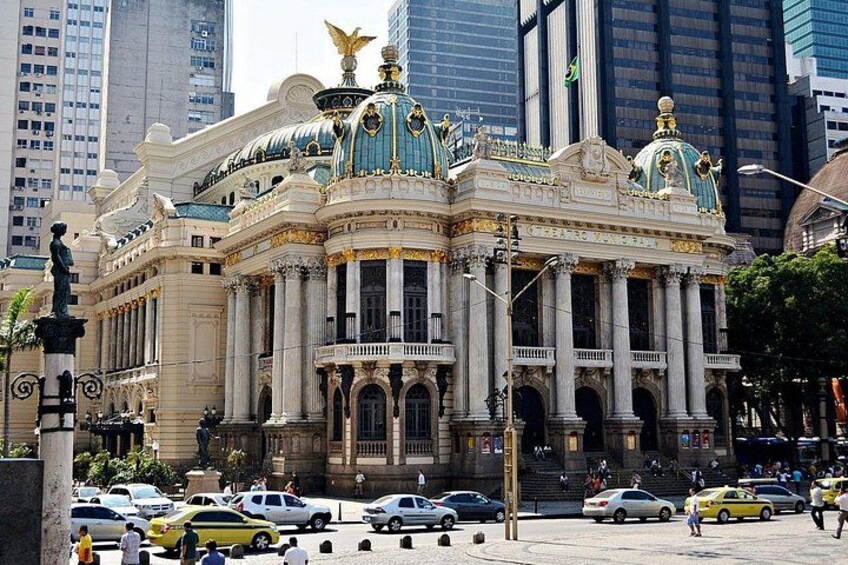 Un edificio maestoso e ricco di decorazioni, caratterizzato da architettura a cupola e colonne, circondato da moderni grattacieli e traffico intenso. 3