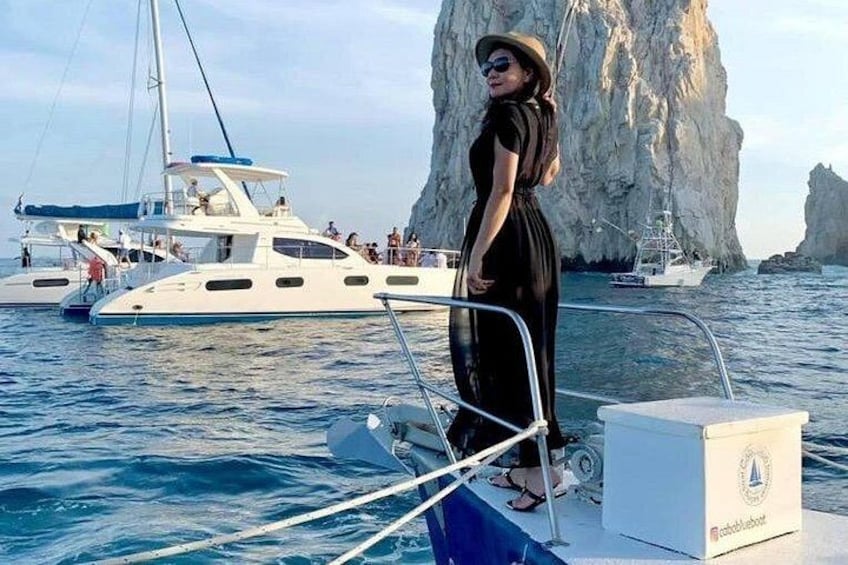 A person on a boat near rocky cliffs. 4