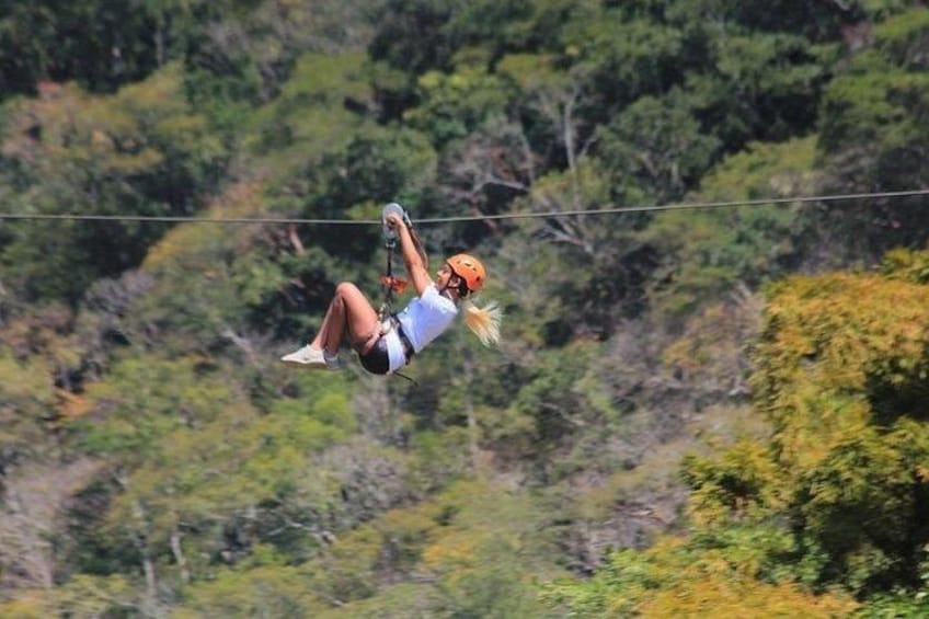 A person zip-lining through a forested area. 3