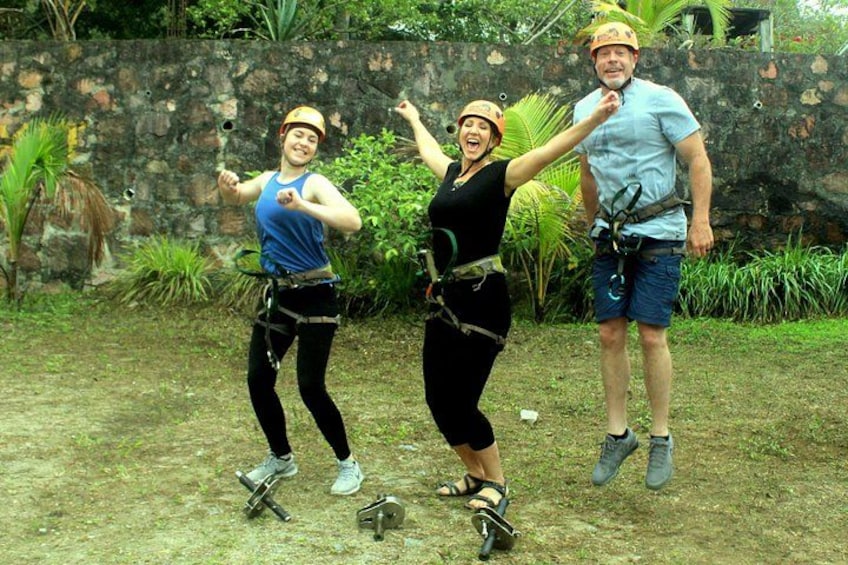 Three people bungee jumping with safety harnesses. 5