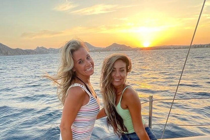 Two people on a boat with a sunset in the background. 5