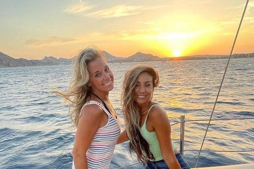 Two people on a boat with a sunset in the background. 4