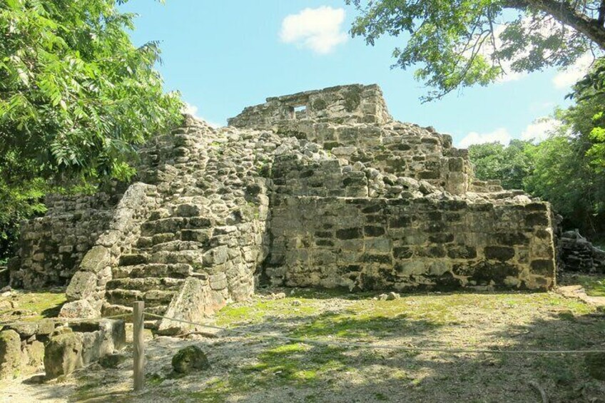 Ancient stone ruins with a staircase leading up to a structure. 1