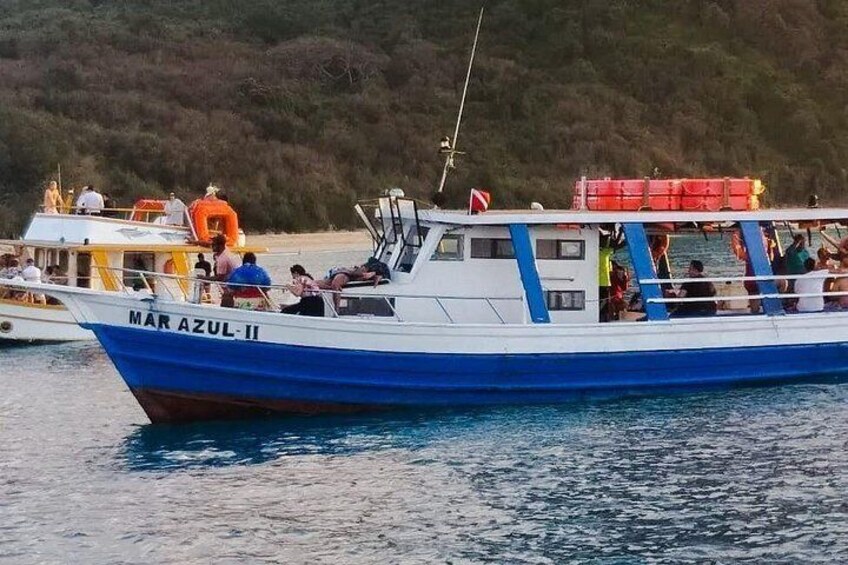 A boat named MAR AZUL II on calm waters with a forested shoreline in the background. 2