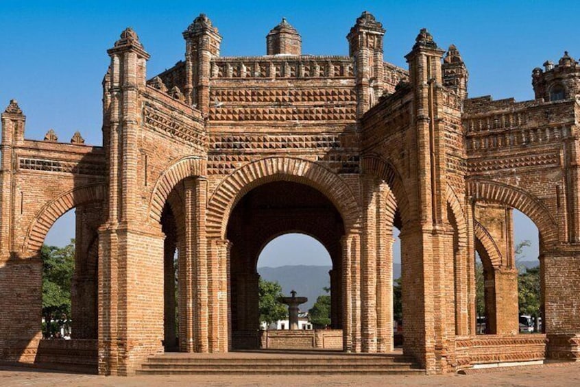 A large, ornate stone archway with intricate carvings and multiple smaller arches on either side. 2