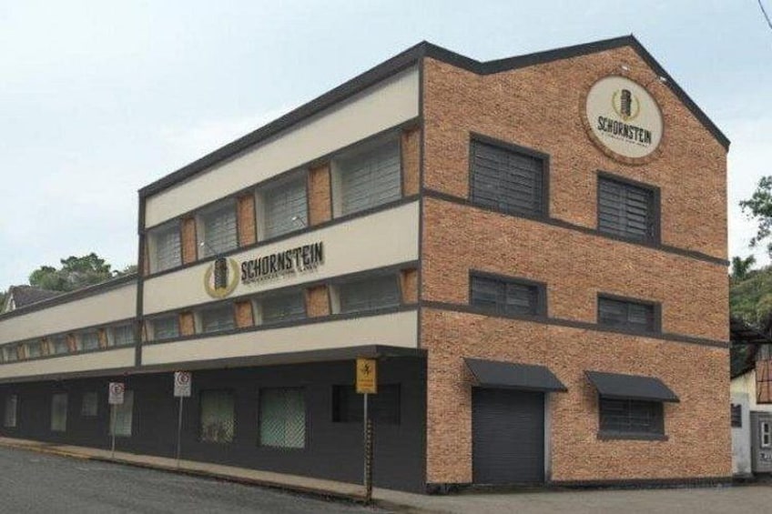 A two-story building with the name 'SCHORNSTEIN' on the facade. 4