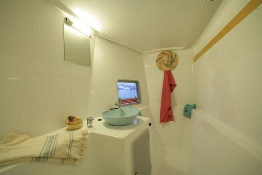 A bathroom with a sink, mirror, and a towel rack. 4
