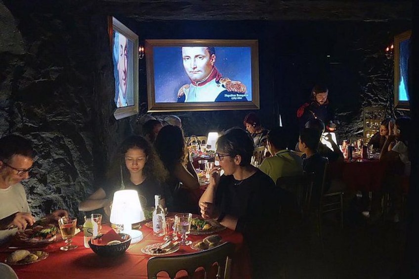 A dimly lit restaurant with patrons dining. 4