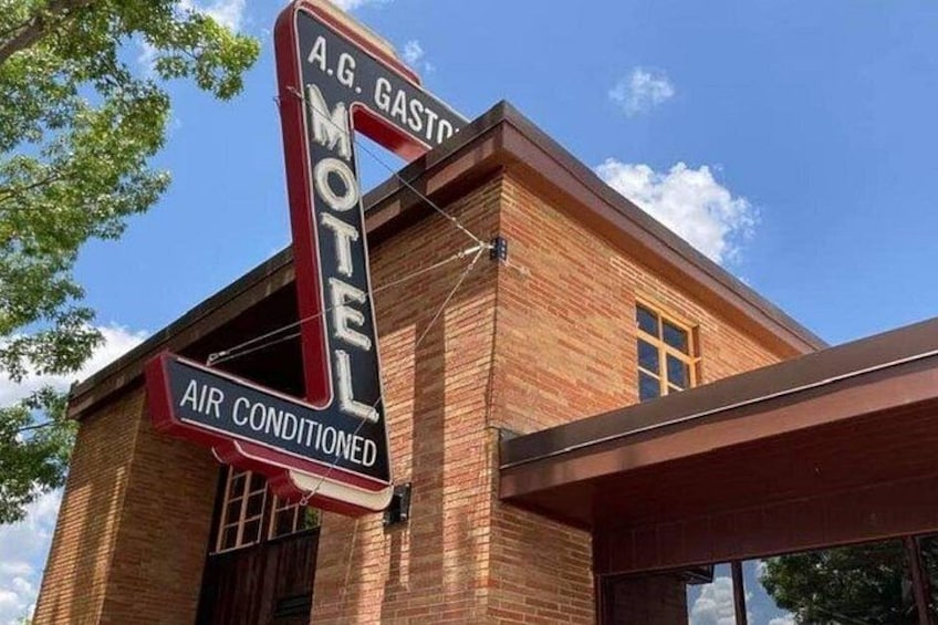 A motel sign with 'A.G. Gasto' and 'Air Conditioned' text. 1