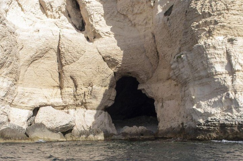 A natural rock formation with a cave entrance. 5