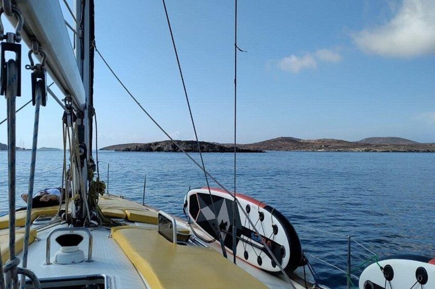 A sailboat's deck with a view of calm waters and distant land. 2