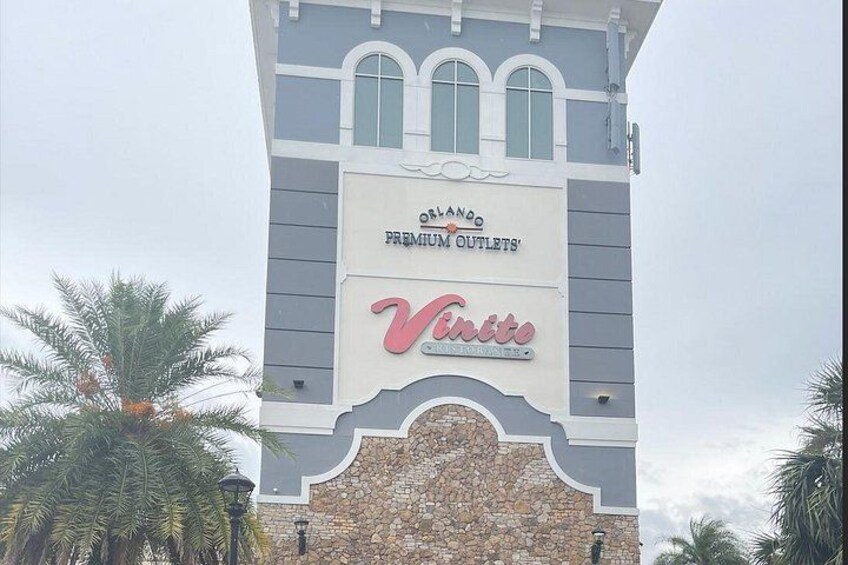A building with a sign that reads 'Orlando Premium Outlets' and 'Venita.' 2