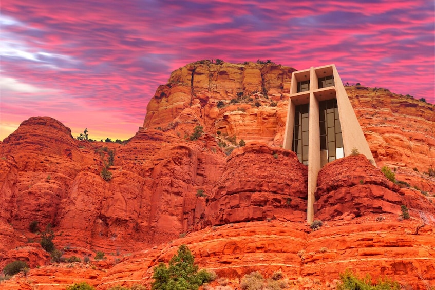 A modern building with a unique design, situated in a red rock canyon with a dramatic sky. 5