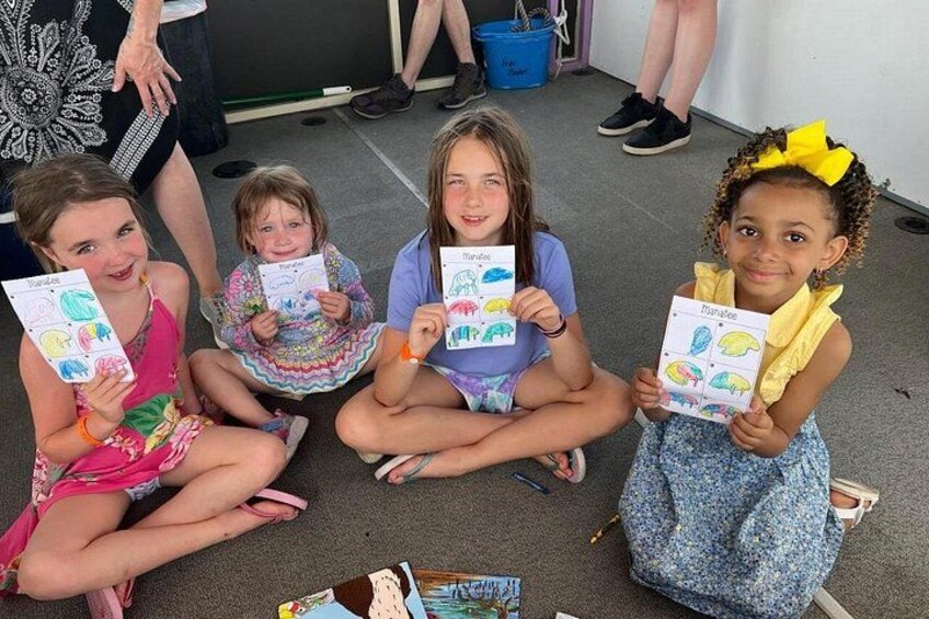 Four children holding drawings. 2