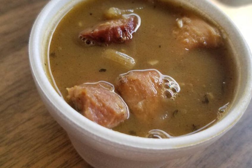 A bowl of soup with chunks of meat and a clear broth. 3