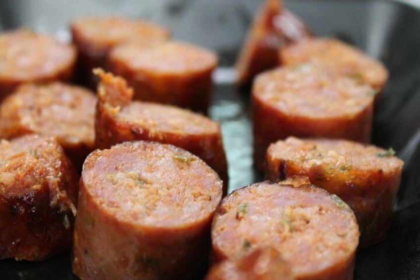 Sliced sausages on a grill. 2