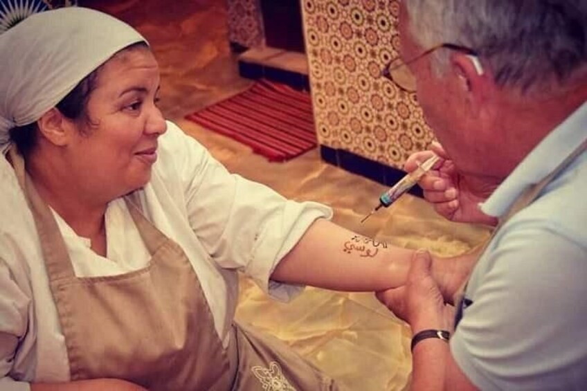 A person getting a tattoo on their arm. 5