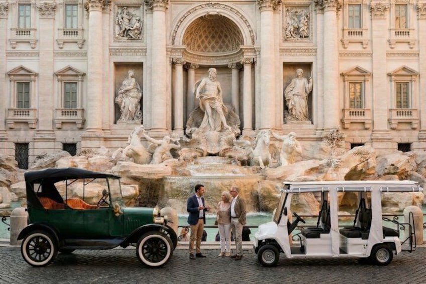 A historic fountain with statues in front of a grand building. 1