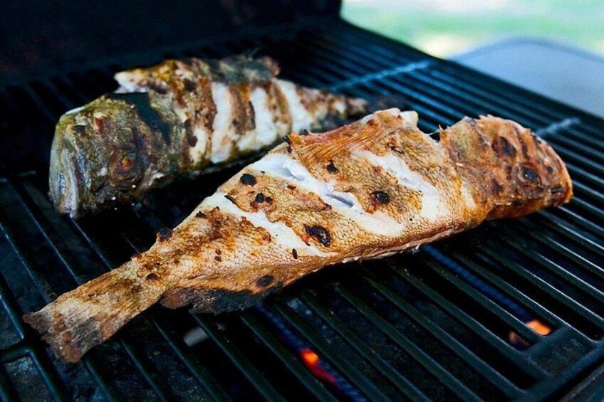 Two grilled fish on a grill. 4