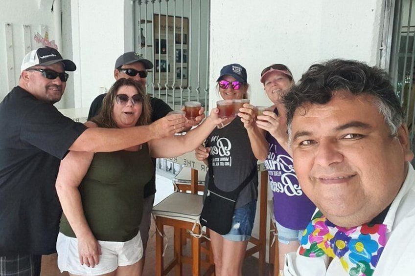 A group of people toasting with drinks on a balcony. 5