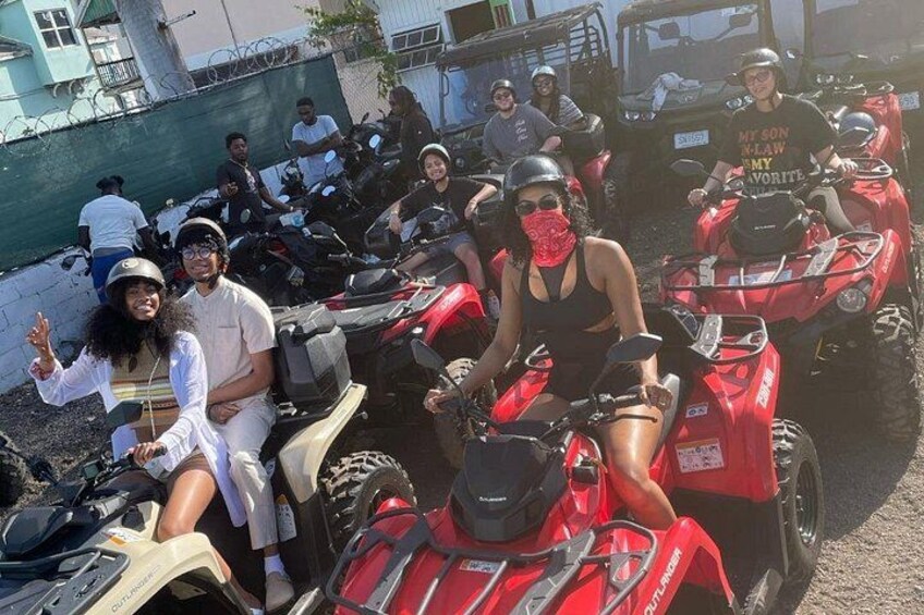 A group of people on ATVs in a parking lot. 2