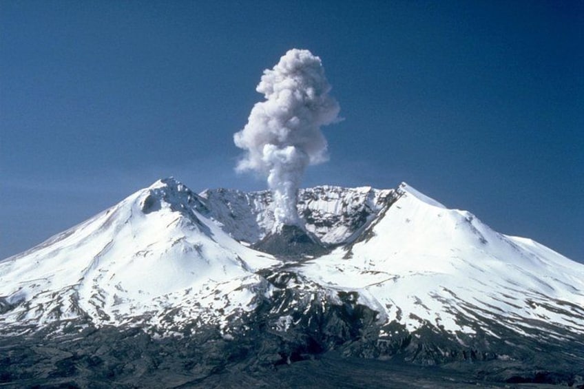 A snow-covered mountain with a volcanic eruption. 1