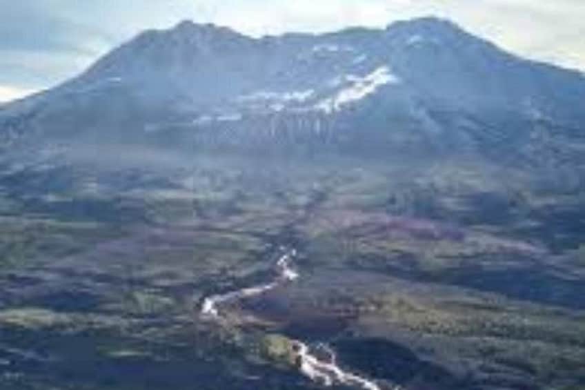 A mountain with a river flowing through a valley. 3