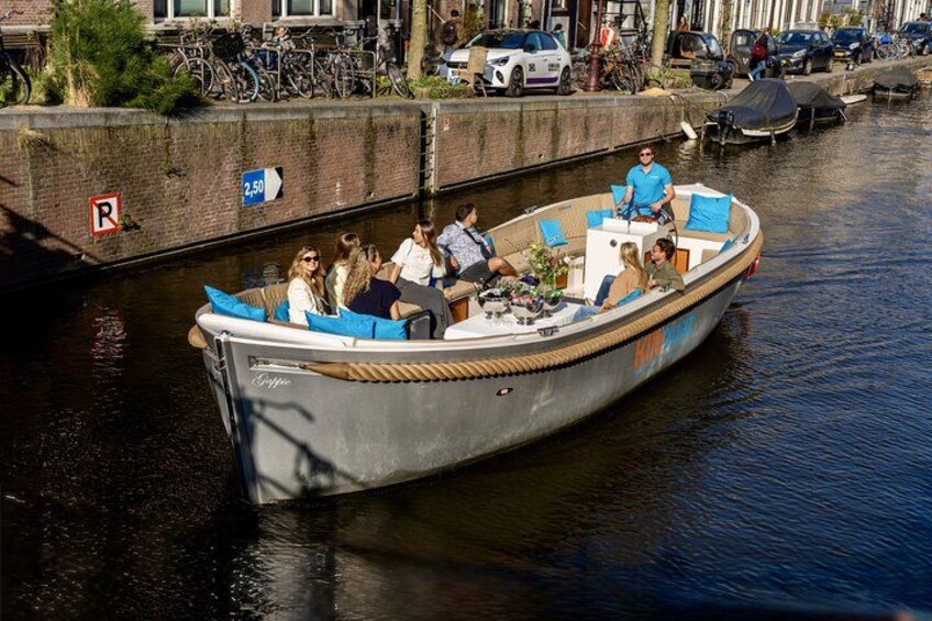 A narrow canal with a boat carrying passengers. 5
