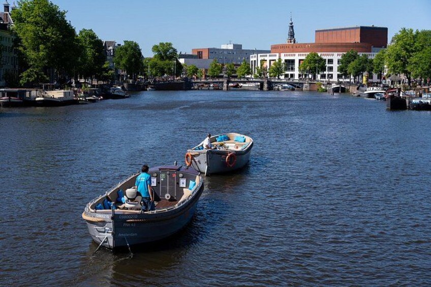 Two boats on a river with buildings in the background. 4