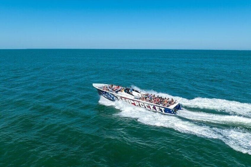 A speedboat with 'Brock' written on it, moving across a body of water. 1