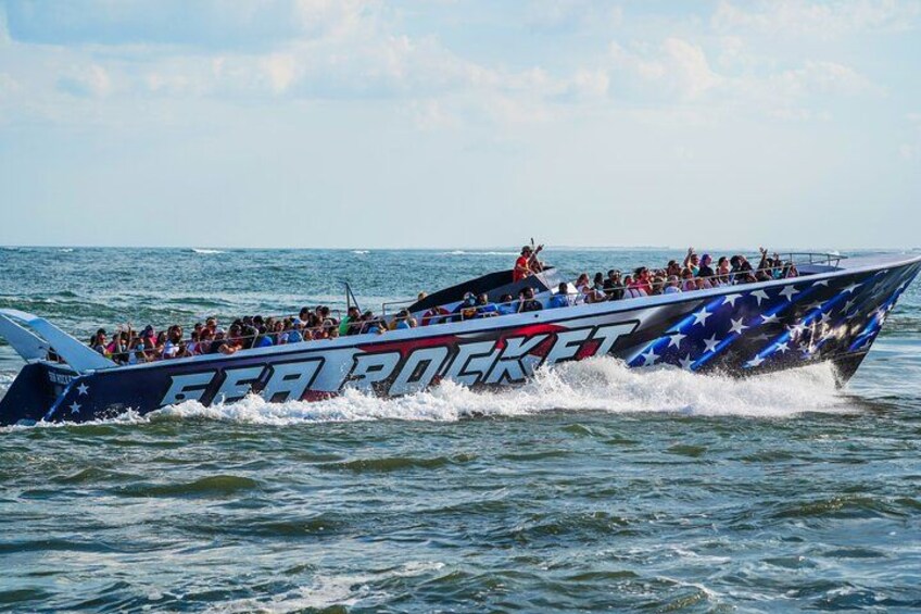 A speedboat with 'FEAR OF' written on its side, racing on the water. 3