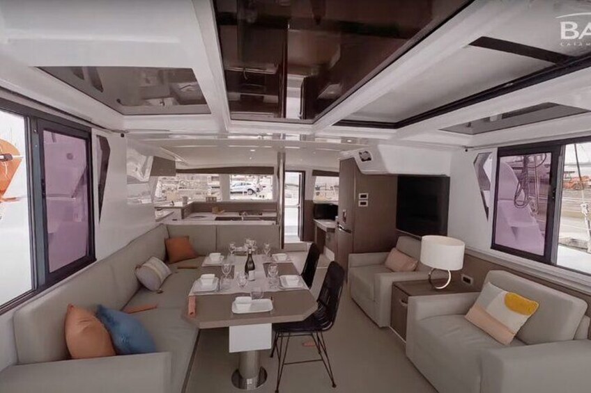 A modern interior with a dining area, sofas, and a kitchen. 3