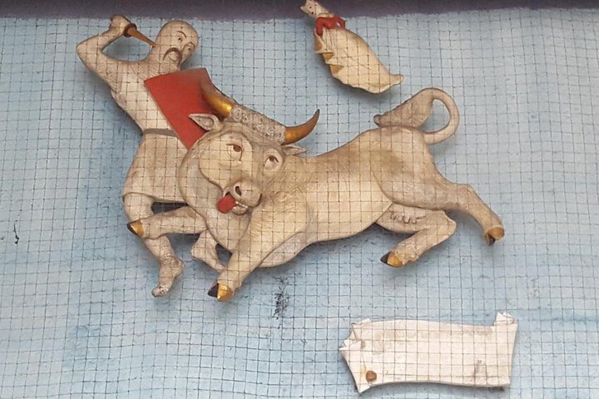 A bull and a man sculpture on a grid surface. 4