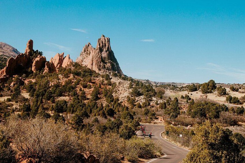 A mountainous landscape with rocky formations and a winding road. 3
