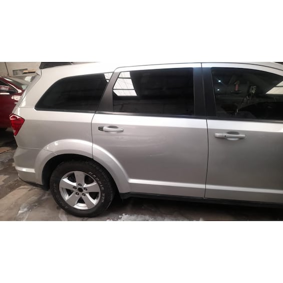 A silver SUV parked in a garage. 3