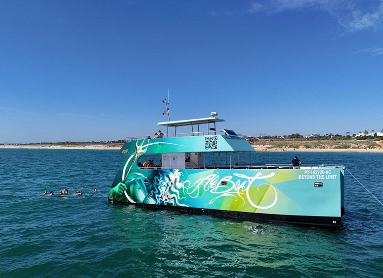 A colorful boat with a QR code and the text 'Beyond the Limit' on its side, floating on calm waters with a beach and clear sky in the background. 4