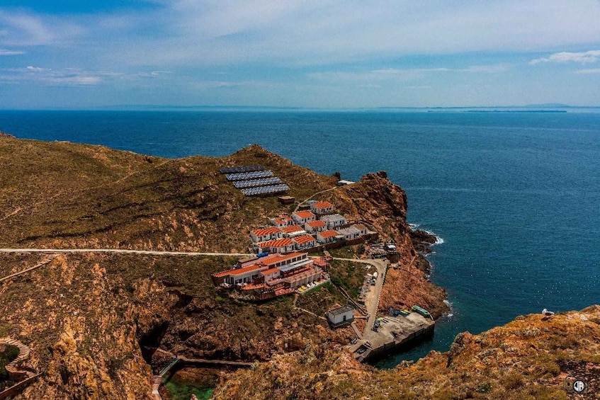 A coastal village with terraced houses and solar panels. 5